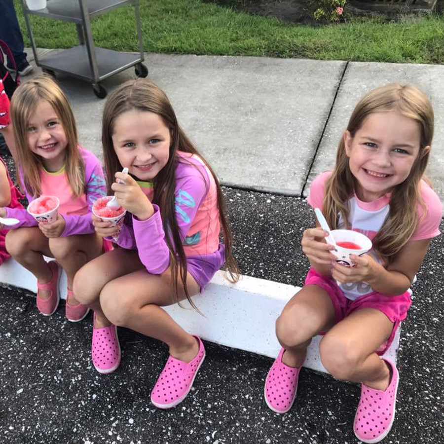 Three children eating snow cones