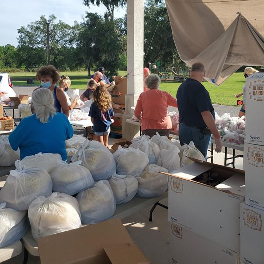 People distributing large bags of food