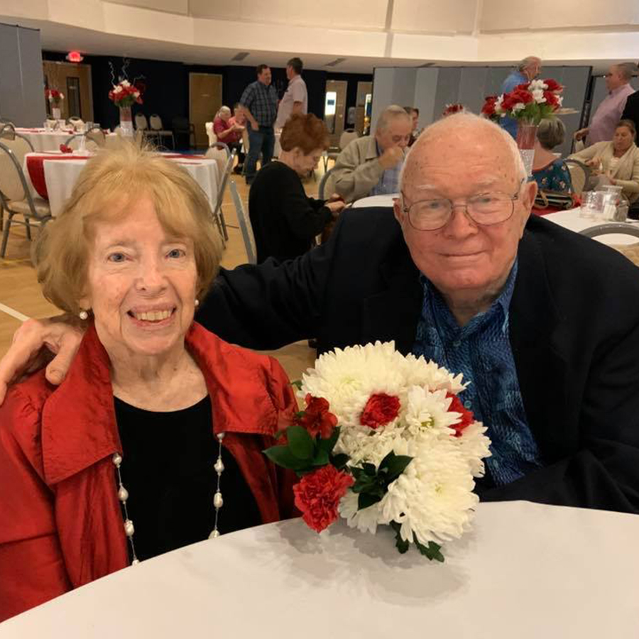 Older couple at Table decorated with flowers